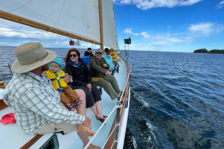 a person sitting in a boat on a body of water