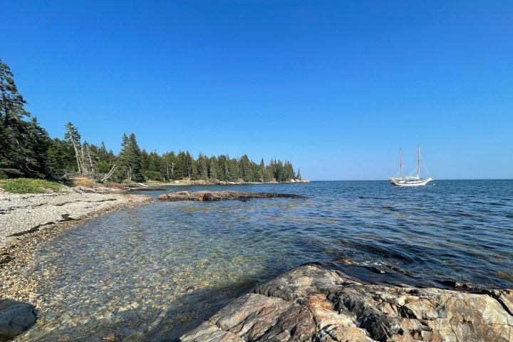 a rocky beach next to a body of water
