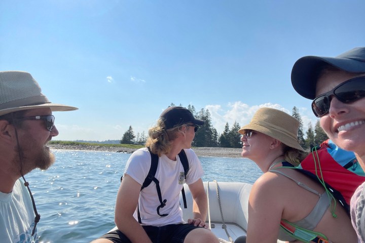 a couple of people that are drinking water from a boat