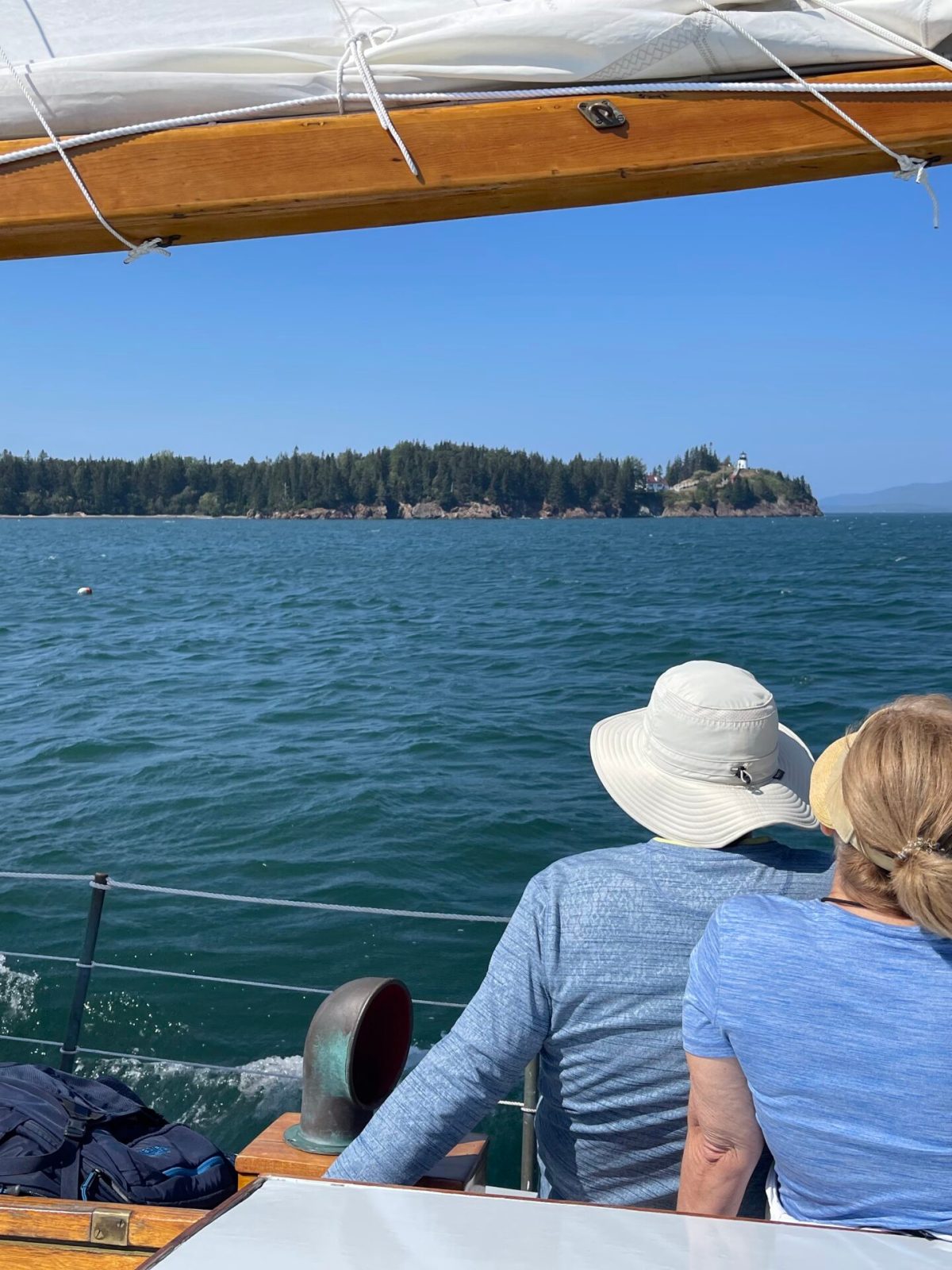 a person sitting on a dock next to a body of water