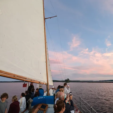a group of people standing next to a body of water