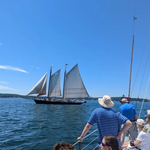 a group of people in a boat on a body of water