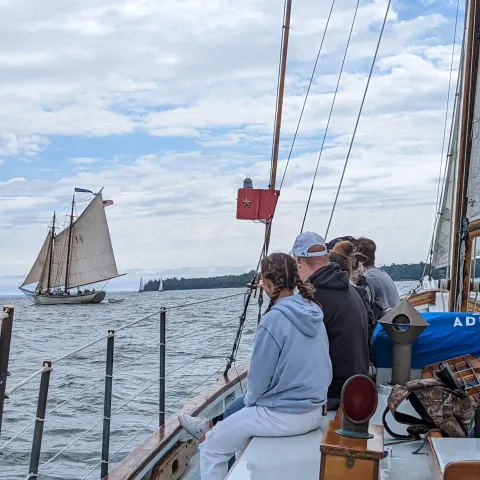 a woman riding on the back of a boat