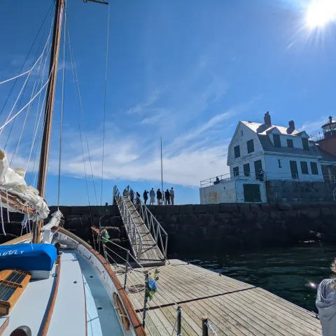 a group of people in a boat on a body of water