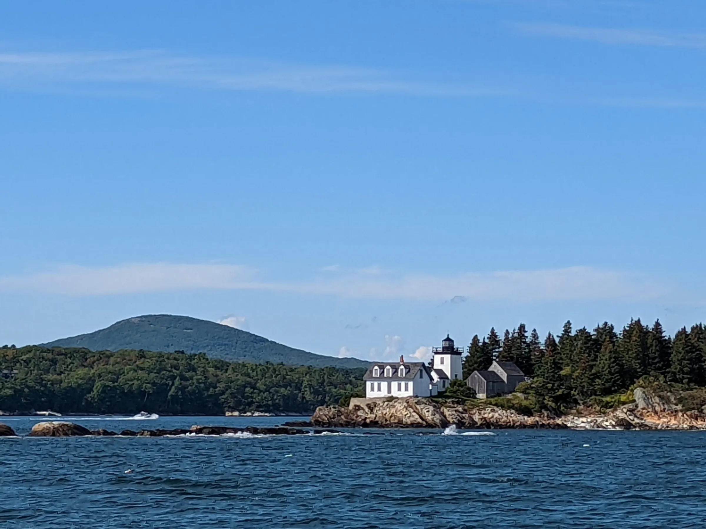 a large body of water with a mountain in the background