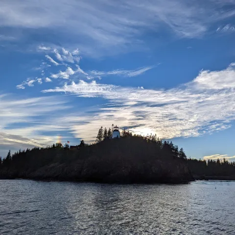 a large body of water with a mountain in the background