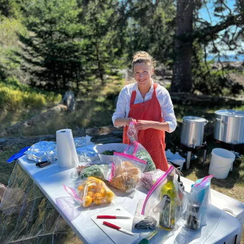 a man and a woman sitting at a picnic table