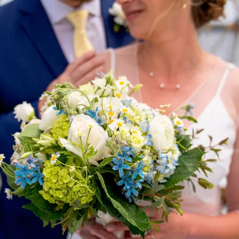 a couple of people that are standing in front of a flower